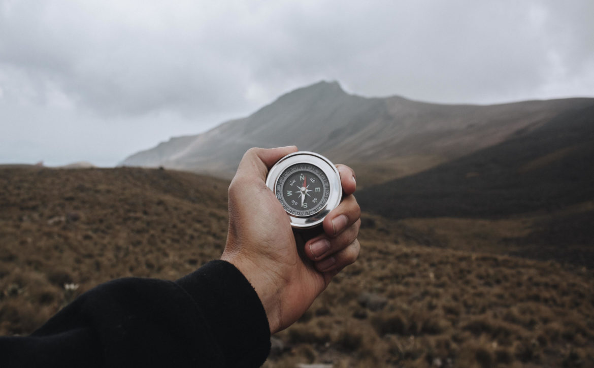 Closeup shot of a person holding a compass